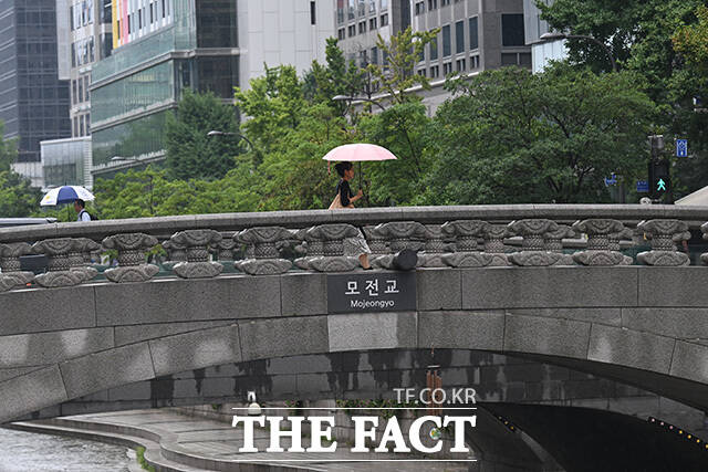 관광객들이 청계천을 바라보고 있다.