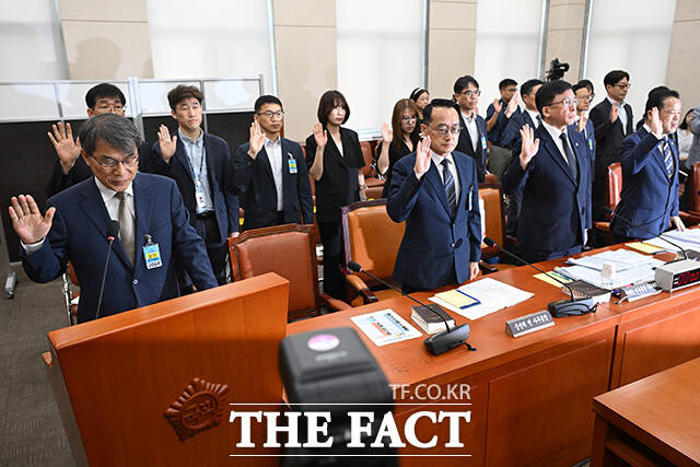노태악 전 중앙선거관리위원장(왼쪽) 및 참석자들이 10일 오전 서울 여의도 국회에서 열린 제9회 전국동시지방선거 투표용지 부족 사태 등 국민 참정권 침해 진상규명 및 선거관리 개혁을 위한 국정조사 특별위원회 제3차 청문회에서 증인 선서를 하고 있다. /국회=남용희 기자