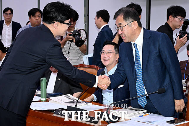 맹성규 더불어민주당 의원(오른쪽)과 인사하는 한 의원.