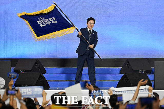 김민석 더불어민주당 신임 당대표가 17일 오후 대전 유성구 대전컨벤션센터에서 열린 더불어민주당 제3차 정기전국당원대회에서 당기를 흔들고 있다. /대전=남용희 기자