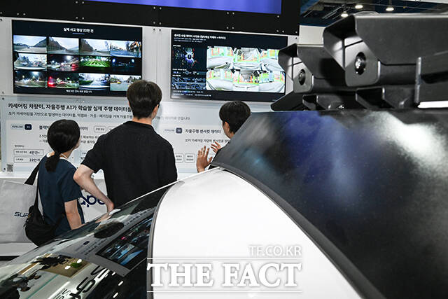 '2026 자율주행모빌리티산업전'을 찾은 관람객들이 쏘카의 자율주행 AI 주행 데이터 학습과 관련한 설명을 듣고 있다.