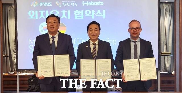 충남도와 당진시, 독일 베바스토그룹이 25일(현지시각) 독일 프랑크푸르트 슈타이겐베르거 호텔에서 1350만 달러 규모의 투자양해각서(MOU)를 체결한 가운데 김기재 당진시장(왼쪽부터), 박수현 충남도지사, 마르셀 바틀링 베바스토그룹 부회장이 협약서를 들고 기념 촬영을 하고 있다. /충남도