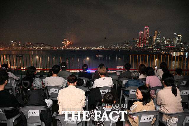 '2025 서울세계불꽃축제'가 27일 오후 서울 여의도 일대에서 열린 가운데 서울 마포구 마포365구민센터에서 구민들이 불꽃축제를 감상하고 있다. /더팩트 DB