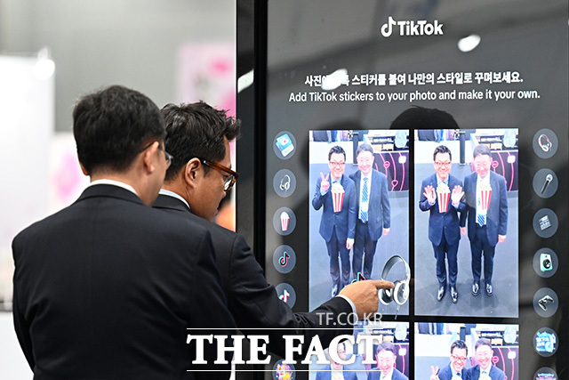틱톡 부스에서 스티커 사진을 찍는 방문객.