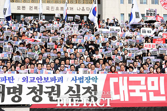장동혁 국민의힘 대표 및 참석자들이 22일 오전 서울 여의도 국회 앞 계단에서 열린 이재명 정권 실정 대국민 보고대회에서 구호를 외치고 있다. /남용희 기자