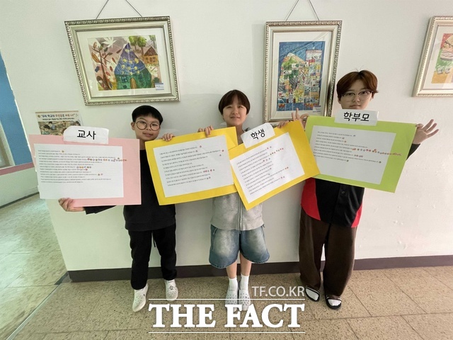 근흥초등학교 학생들이 주체별 학교문화책임규약 실천 규칙이 선정됨에 따라 교사, 학생, 학부모의 역할이 담긴 피켓을 들고 있다. /충남도교육청