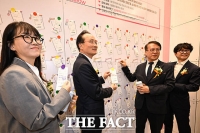  구직 응원 메시지 붙이는 장항준 감독-김은희 작가 부부와 이환주 KB국민은행장 [TF사진관]