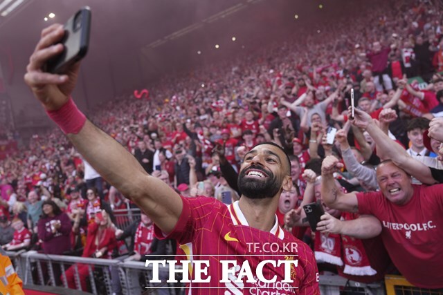 리버풀 우승의 일등공신 모하메드 살라가 28일 토트넘과 2024~2025 EPL 34라운드 홈 경기에서 후반 18분 추가골을 넣은 뒤 팬의 휴대폰으로 셀카를 찍는 세리머니를 펼치고 있다./리버풀=AP.뉴시스