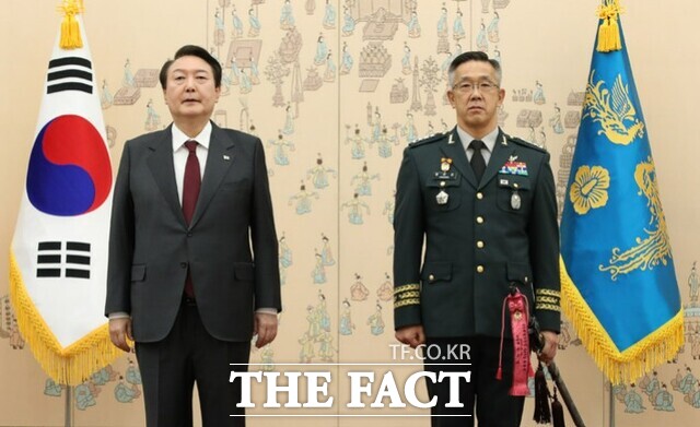 윤석열 대통령이 2022년 12월 7일 서울 용산 대통령실 청사에서 열린 장성 보직 신고 및 삼정검 수치 수여식에서 황유성 국군방첩사령관의 삼정검에 수치를 달아준 뒤 기념촬영하고 있다. /뉴시스