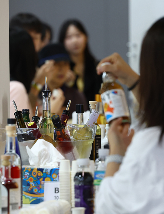 지난해 aT센터에서 열린 2024 대한민국 우리술 대축제에서 관람객들이 각종 술을 살펴보며 시음하고 있다./뉴시스