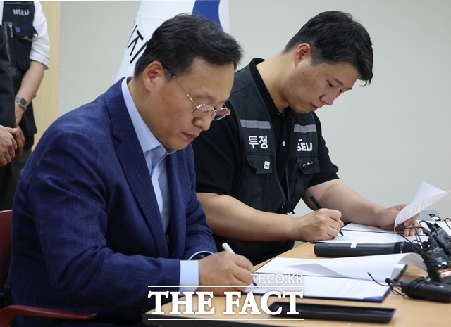 여명구 삼성전자 DS 피플팀장(왼쪽)과 최승호 초기업노조삼성전자지부 위원장이 지난 20일 경기 수원시 장안구 경기지방고용노동청에서 열린 삼성전자 노사 교섭 결과 브리핑에서 합의안에 서명하고 있다. /뉴시스