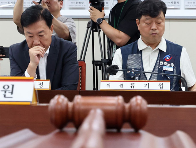 26일 세종시 정부세종청사에서 열린 최저임금위원회 2차 전원회의에서 류기정 사용자 위원과 류기섭 근로자 위원이 의사봉 앞에 나란히 앉아 있다./뉴시스